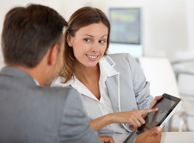 Young woman presenting business plan to financial investor