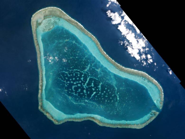 China to build on disputed shoal in South China Sea