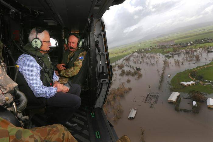 Tens of thousands told to evacuate after cyclone brings flood fears to Australia east