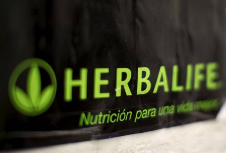 Herbalife raises profit forecast, tops key FTC threshold