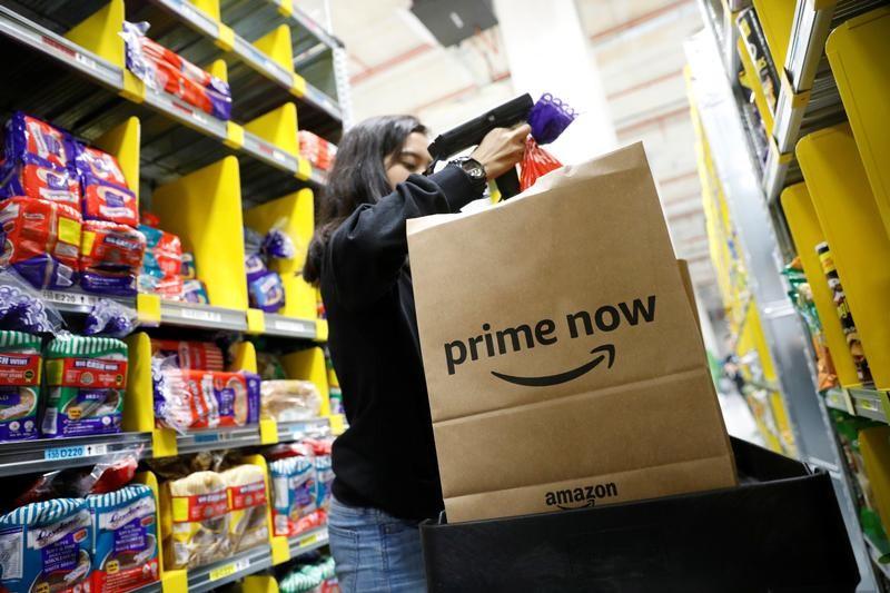 Amazon plows ahead with high sales and spending; profit plunges