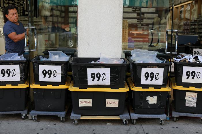 A Man Prepares His Store For Business In Downtown Los Angeles