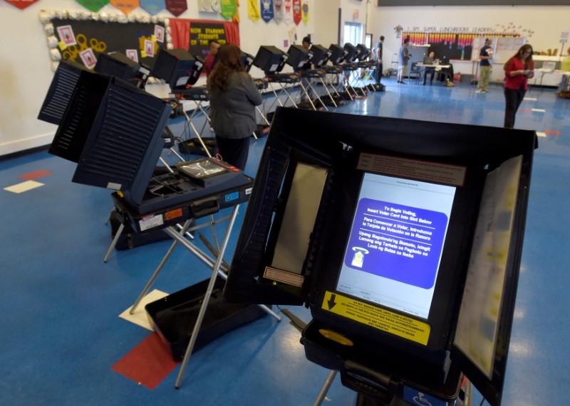 Hackers scour voting machines for election bugs