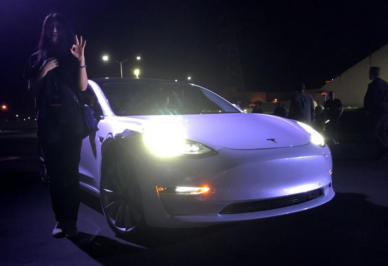 Tesla Musk hands over first Model 3 electric cars to early buyers