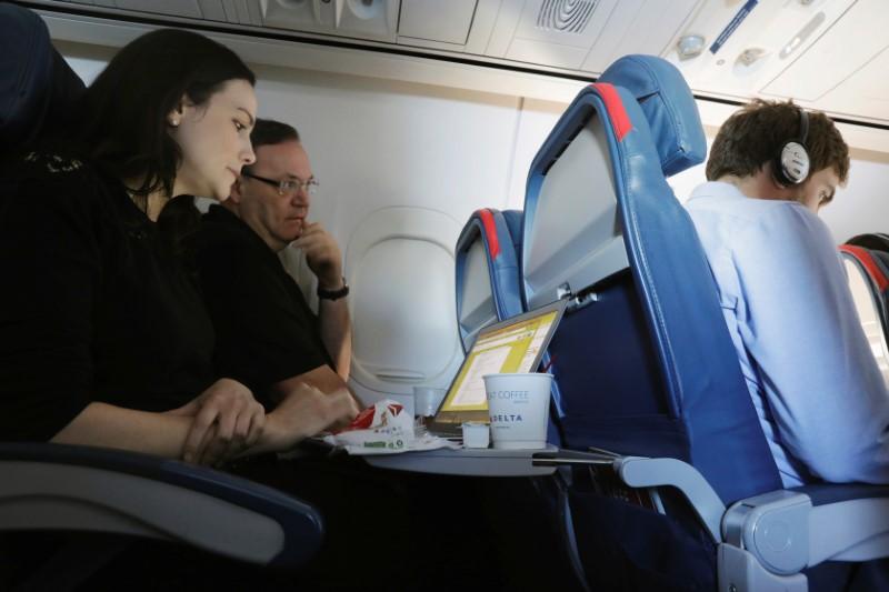 A woman uses her laptop on a flight out of jfk international airport in new york