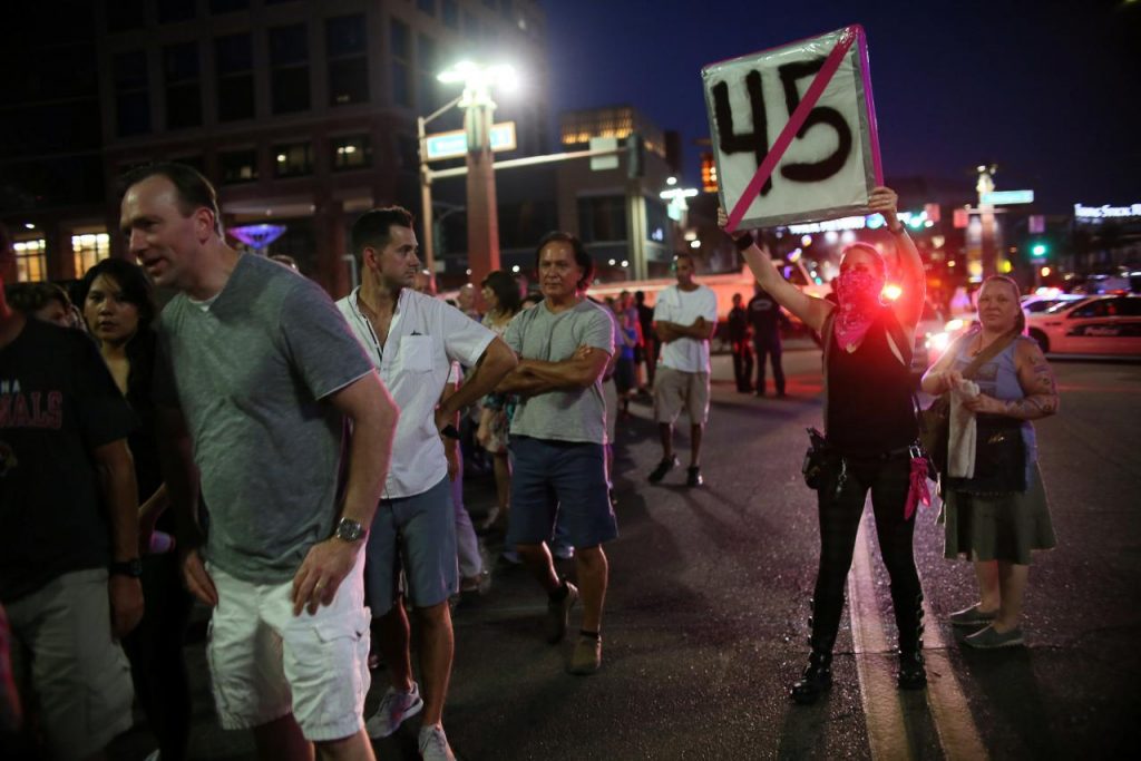 Police fire pepper spray to disperse protesters outside Trump rally in Phoenix