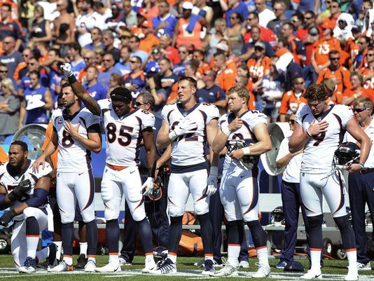 More than 200 NFL players sit or kneel during anthem