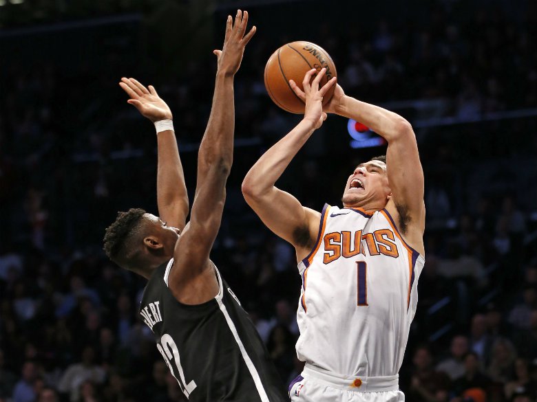 Booker scores 32, Suns rally late to beat Nets 122-114