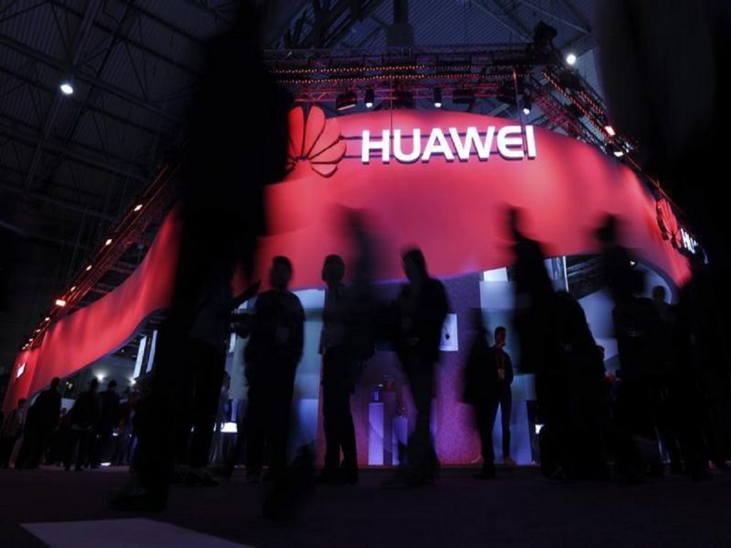 Visitors walk past Huawei's booth during Mobile World Congress in Barcelona