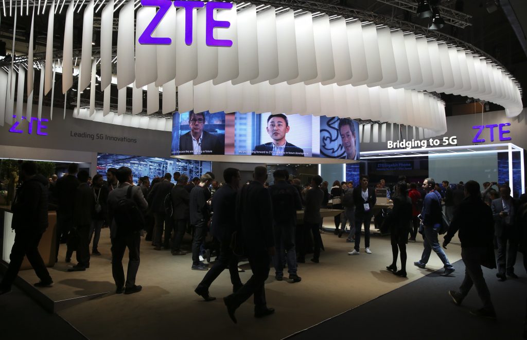 People stand at ZTE's booth during Mobile World Congress in Barcelona