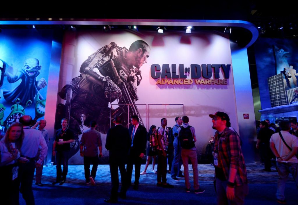 FILE PHOTO: Attendees walk pass a giant billboard promoting the new multiplayer action game "Call of Duty: Advanced Warfare" in Los Angeles